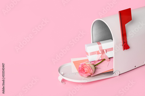Mailbox with letters, gift and rose on pink background. Valentine's Day celebration