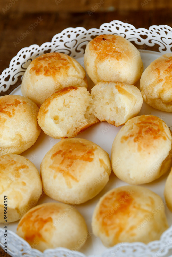 Portion of traditional Brazilian cheese bread on white tray