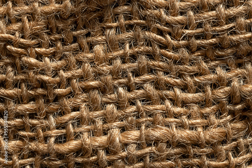 Texture of natural burlap material close-up, with natural folds and draperies
