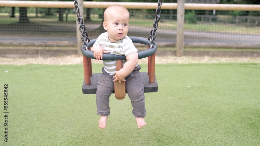 Funny Little Younger Newborn Infant Brother Boy On Swing. Baby Playing On Playground. Summer time outside. Kids Entertainment, Childhood, Child Development, Happy Family Concept Funny Little Younger Newborn Infant Brother Boy On Swing. Baby Playing On Playground. Summer time outside. Kids Entertainment, Childhood, Child Development, Happy Family Concept