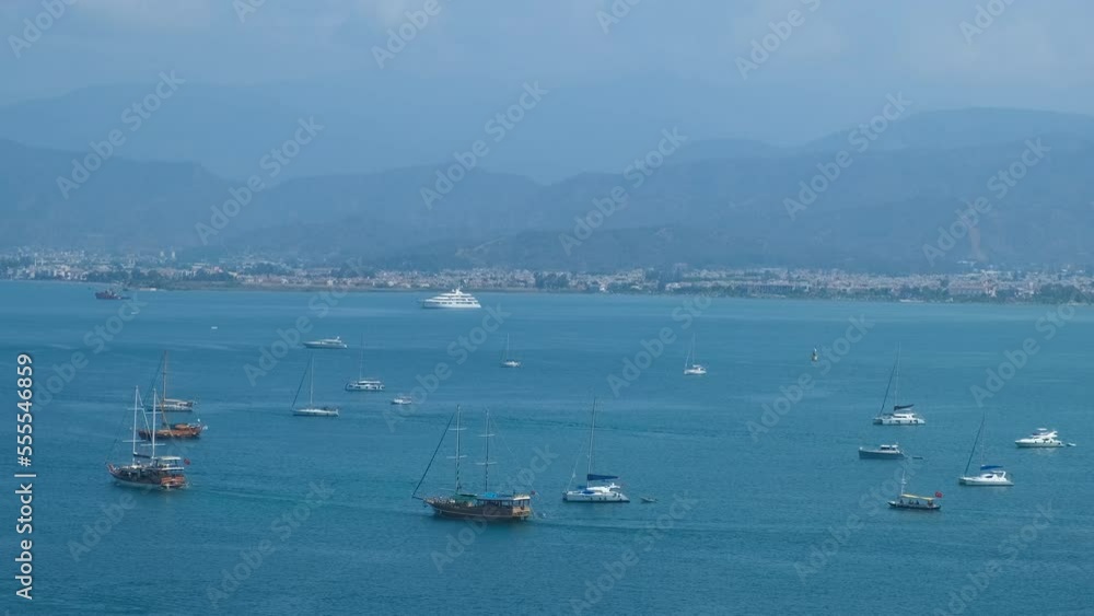 Pierces with speed boats. A view of summer pierces with arriving boats and yachts against tropical island.