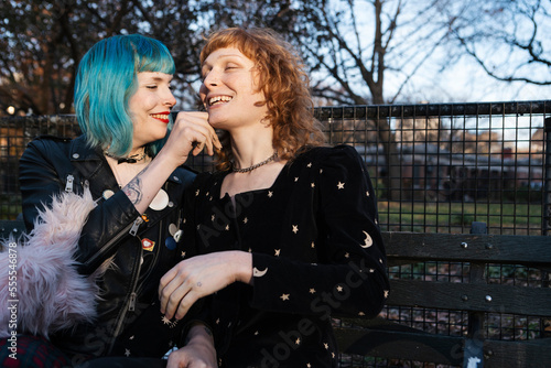 unconventional lesbian couple embracing in urban park