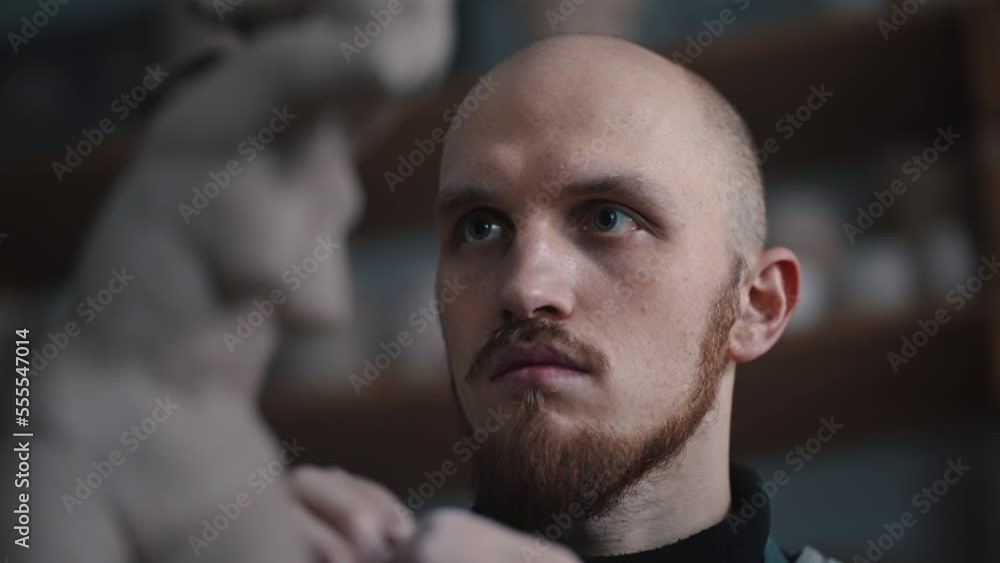 Close-up portrait of a master sculptor man making a clay sculpture, shaping the clay with hands Close-up portrait of a master sculptor man making a clay sculpture, shaping the clay with hands