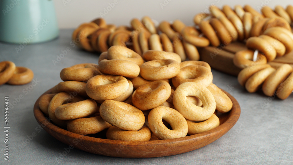 Plate with delicious ring shaped Sushki (dry bagels) on light grey table, closeup Plate with delicious ring shaped Sushki (dry bagels) on light grey table, closeup