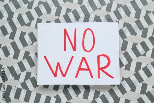 Card with phrase No War and adhesive tape on light background, top view photo