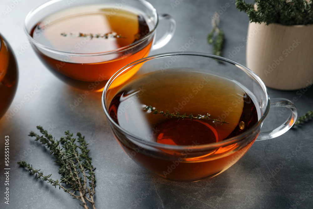 Aromatic herbal tea with thyme on grey table Aromatic herbal tea with thyme on grey table