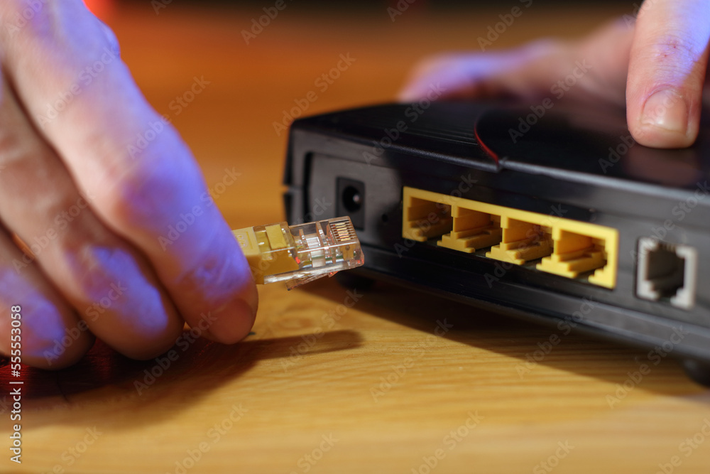 Fotografia connecting internet cable to old adsl modem