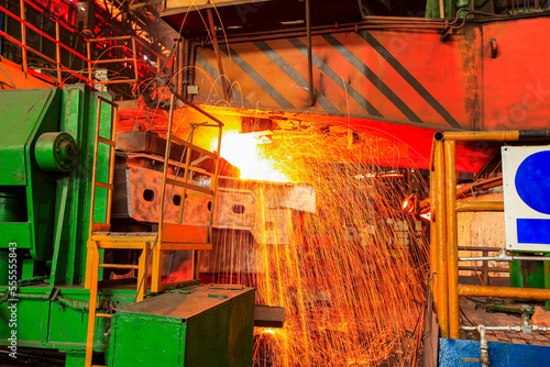 steelworker at work pouring metal in the workshop, Steelmaking workshop