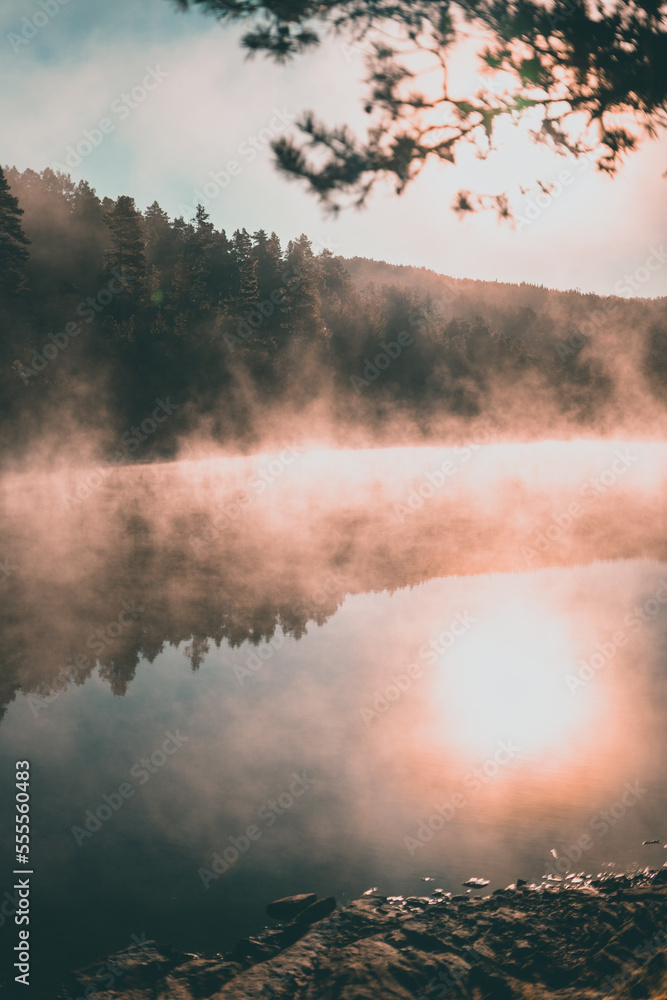 Misty morning at a lake in Norway during sunrise with fog. Misty morning at a lake in Norway during sunrise with fog.