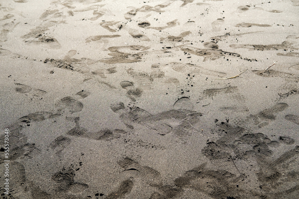 footprints in the beach sand, texture of the sand footprints in the beach sand, texture of the sand