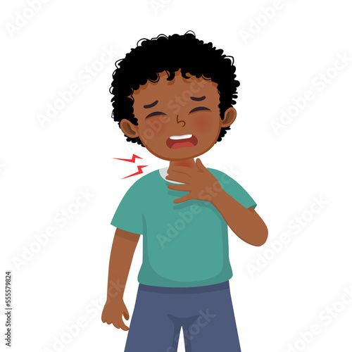 Cute little African boy suffering from sore throat touching his swelling and painful neck as symptoms of flu and allergy

