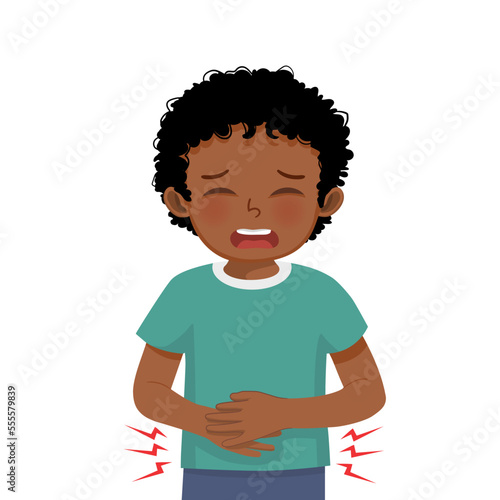 Cute little African boy suffering from stomachache, diarrhea, indigestion problem, abdominal pain, food poisoning, nausea, gastritis or bloating