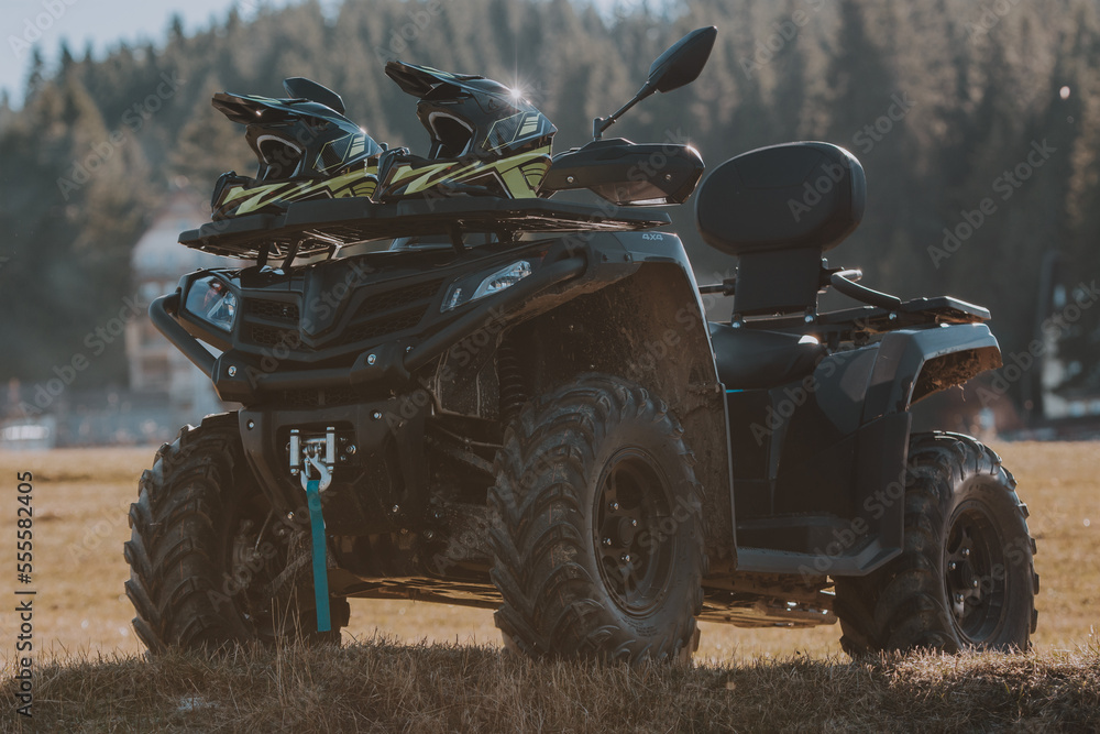 Fototapeta premium Beautiful nature landscape with ATV awd quadbike motorcycle and cloudscape sky background. Offroad adventure trip. Extreme sports activity. Front view. Concept motocross quadricycle background