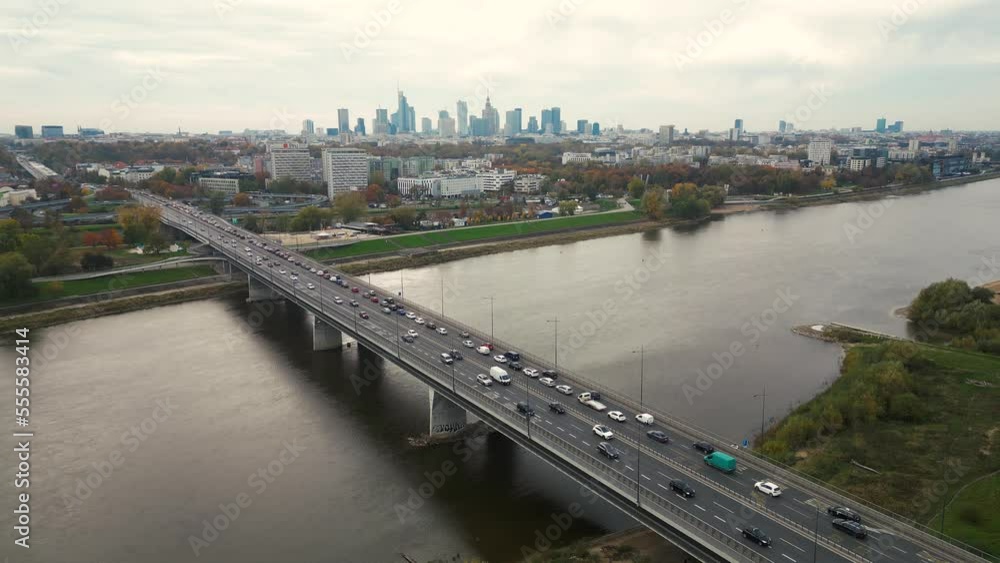 Aerial drone top view of highway multilevel junction in urban populated area, City panorama background. Bridge Warsaw, Poland Aerial drone top view of highway multilevel junction in urban populated area, City panorama background. Bridge Warsaw, Poland