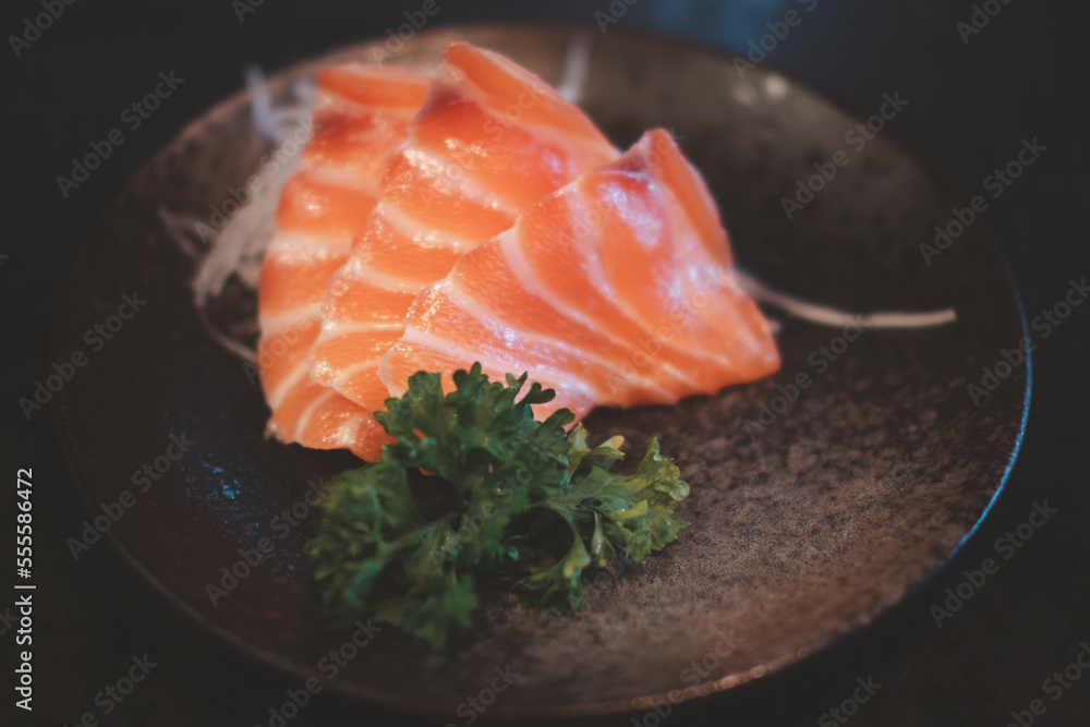 Chopsticks holding raw fresh beef shabu-shabu to pot with hot soup. Japanese shabu-shabu or Sukiyaki. Chopsticks holding raw fresh beef shabu-shabu to pot with hot soup. Japanese shabu-shabu or Sukiyaki.