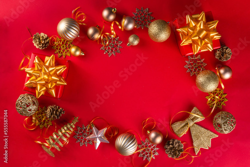  Red and gold Christmas New Year bright flat lay. Luxury gold Xmas Noel ornaments and decorations on red background top view copy space