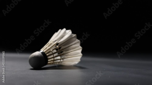 Slow motion of a Shuttlecock falling on a black background. Black background.