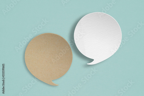 white and brown speech bubble grunge paper cut on grunge green background. Conceptual image about communication and social media, customer feedback