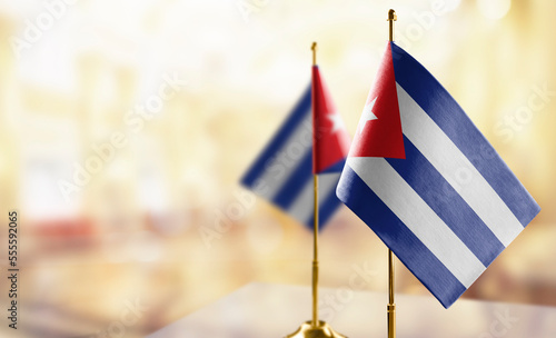 Small flags of the Cuba on an abstract blurry background