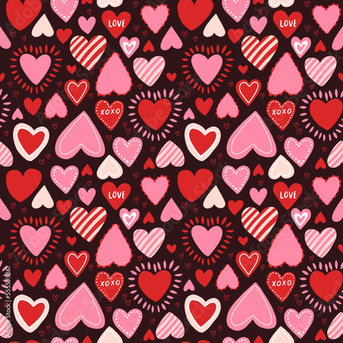 Vector seamless pattern with red and pink hearts. Freehand doodle drawing for valentines day. Can be used on packaging paper, fabric, background for different images, etc.