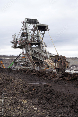 Bucket-wheel excavator during excavation at the surface mine. Huge excavator on open pit mine. 