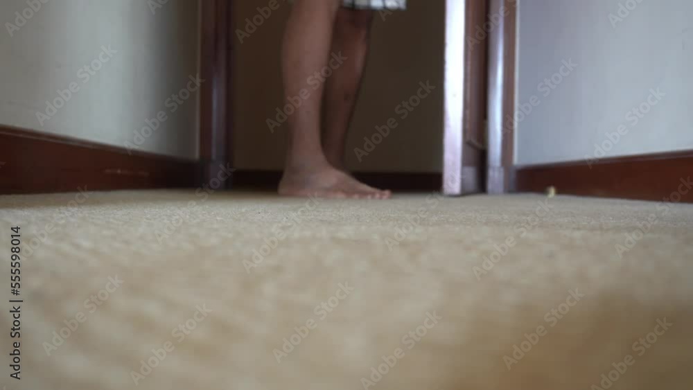 Close up open closing the door and bare foot walking forward in carpet floor
