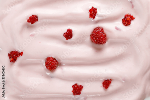 Pink Yogurt with raspberries. Curl of Yogurt. Pink nature yogurt, sour cream, ice cream. Delicious liquid Texture, background. Top view.