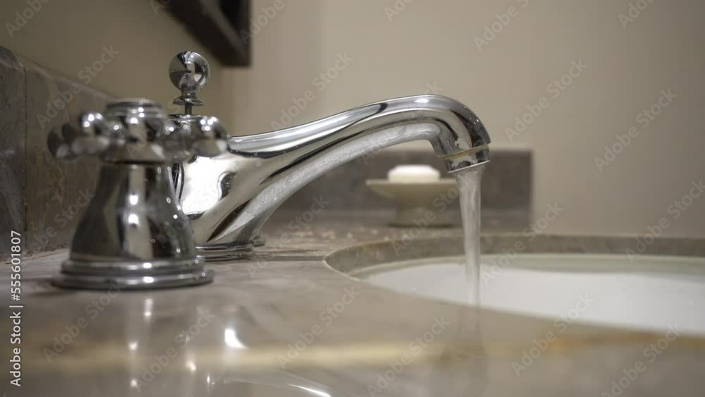 design interior flowing water from metal stainless steel chrome modern faucet in the washbasin design interior flowing water from metal stainless steel chrome modern faucet in the washbasin