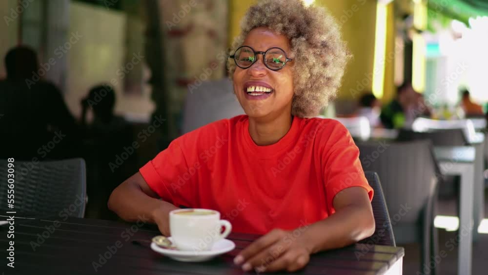 girl with a phone on the street with an afro haircut girl with a phone on the street with an afro haircut