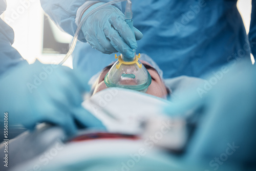 Doctors  surgery and oxygen mask with a medicine team in scrubs operating on a man patient in a hospital. Doctor  nurse and teamwork with a medical group in a clinic to perform an emergency operation