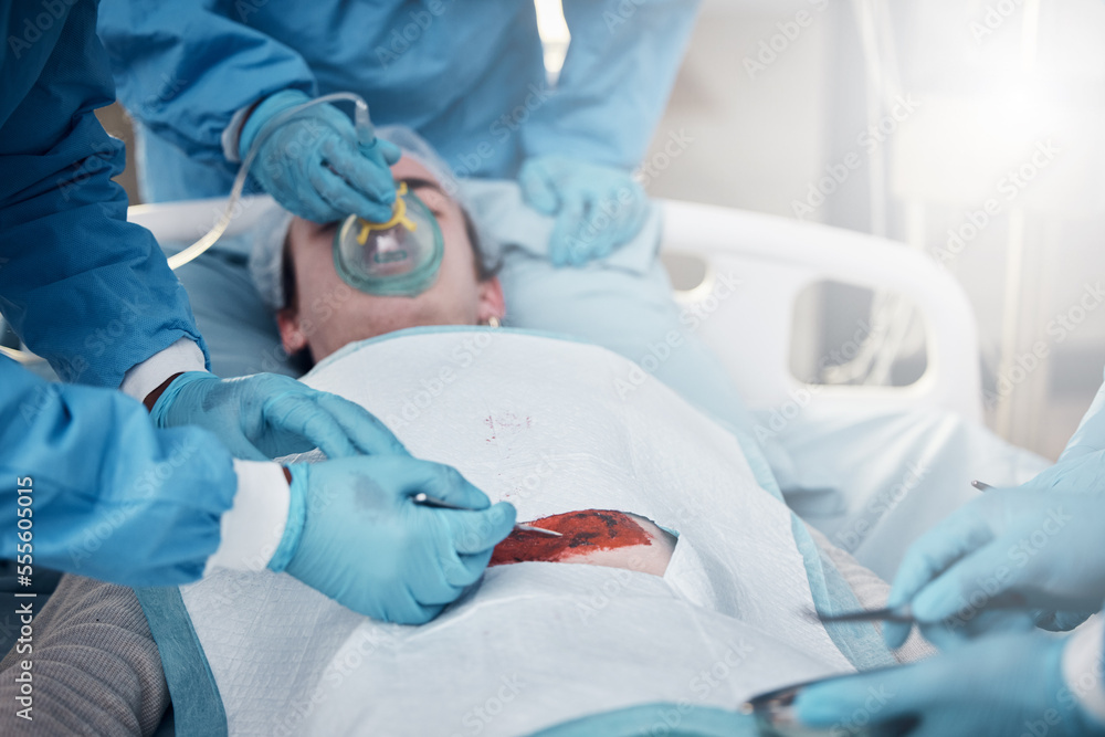 Doctors, surgery and blood with a medicine team in scrubs operating on a man patient in a hospital. Doctor, nurse and teamwork with a medical group in a clinic to perform an operation Doctors, surgery and blood with a medicine team in scrubs operating on a man patient in a hospital. Doctor, nurse and teamwork with a medical group in a clinic to perform an operation