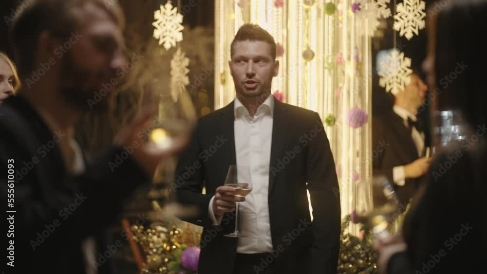 portrait of handsome guy in suit in merry New year party, people have fun in nightclub in evening portrait of handsome guy in suit in merry New year party, people have fun in nightclub in evening