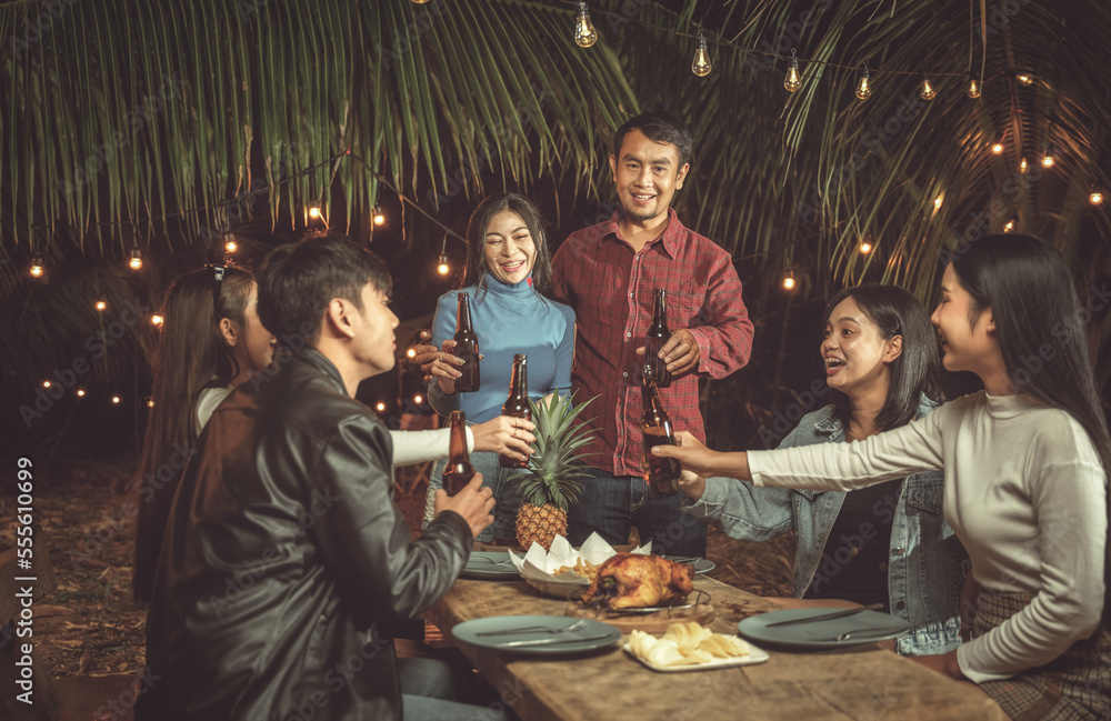 Asian group of friends have dinner party on porch, everyone enjoy in food, drinking and smiling
