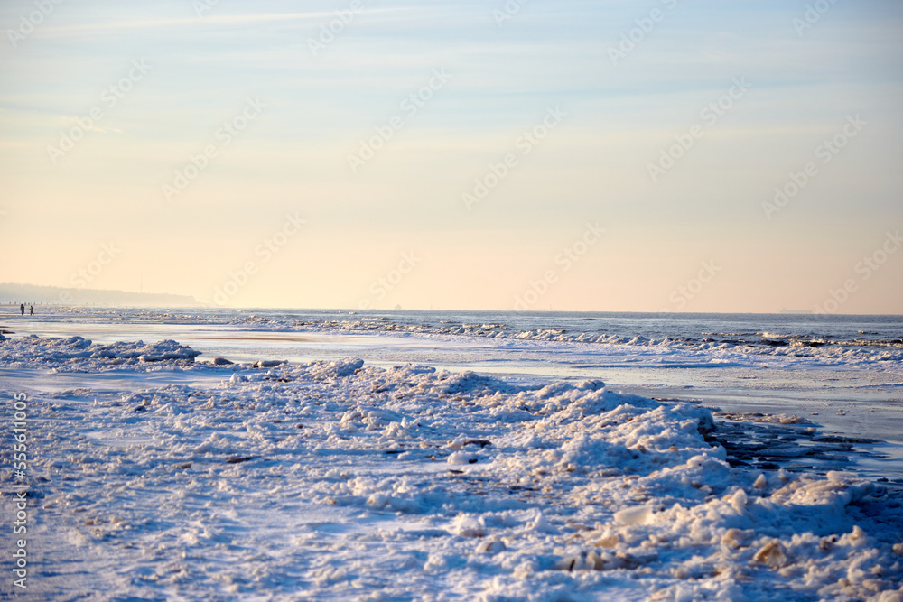 Winter landscape with icy sea coast and calm blue sky, selective focus