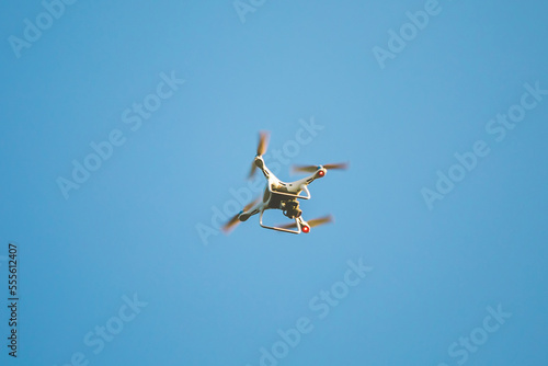 White Drone fly with the blue sky.