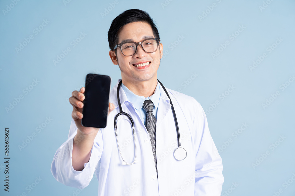 Asian male doctor portrait on blue background Asian male doctor portrait on blue background