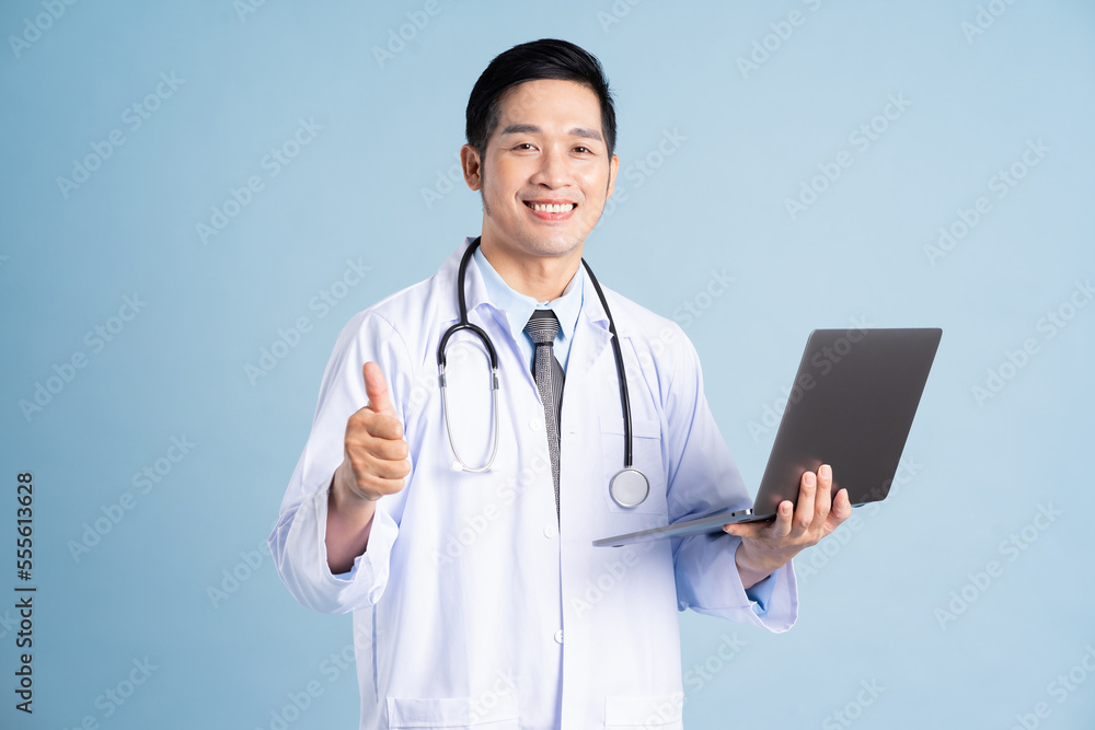 Asian male doctor portrait on blue background Asian male doctor portrait on blue background