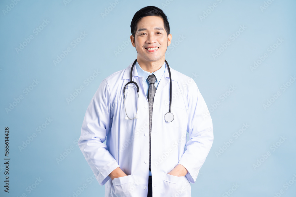 Asian male doctor portrait on blue background Asian male doctor portrait on blue background