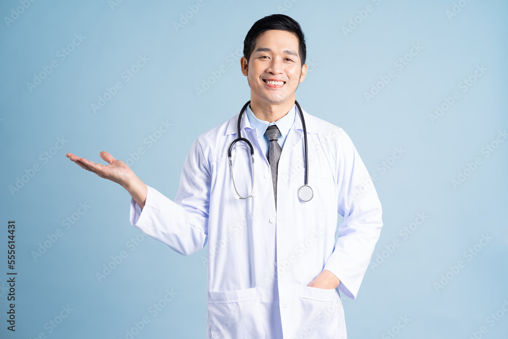Asian male doctor portrait on blue background Asian male doctor portrait on blue background