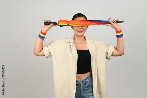 Portrait young asian woman in concept LGBQ with wristband on white background
