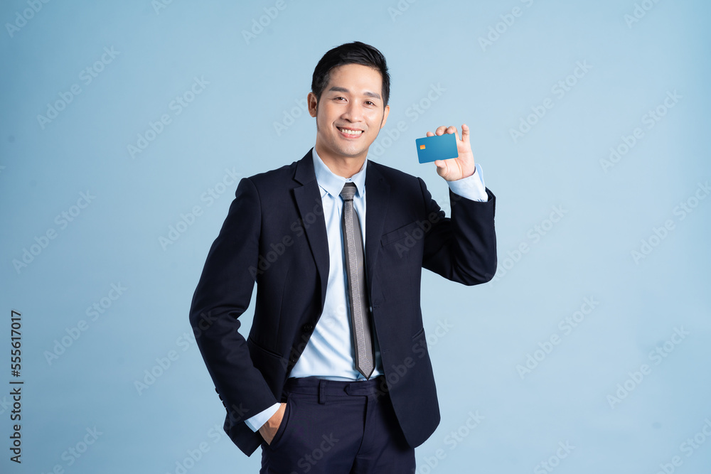 portrait of asian businessman wearing suit on blue background portrait of asian businessman wearing suit on blue background