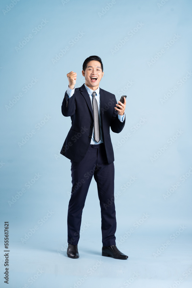 portrait of asian businessman wearing suit on blue background portrait of asian businessman wearing suit on blue background