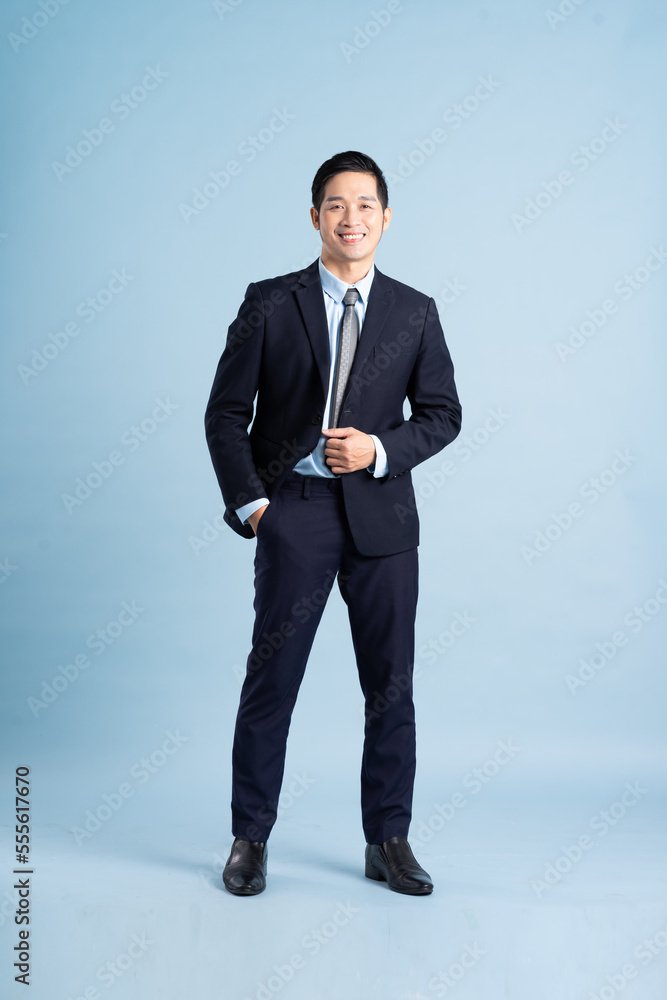 portrait of asian businessman wearing suit on blue background portrait of asian businessman wearing suit on blue background