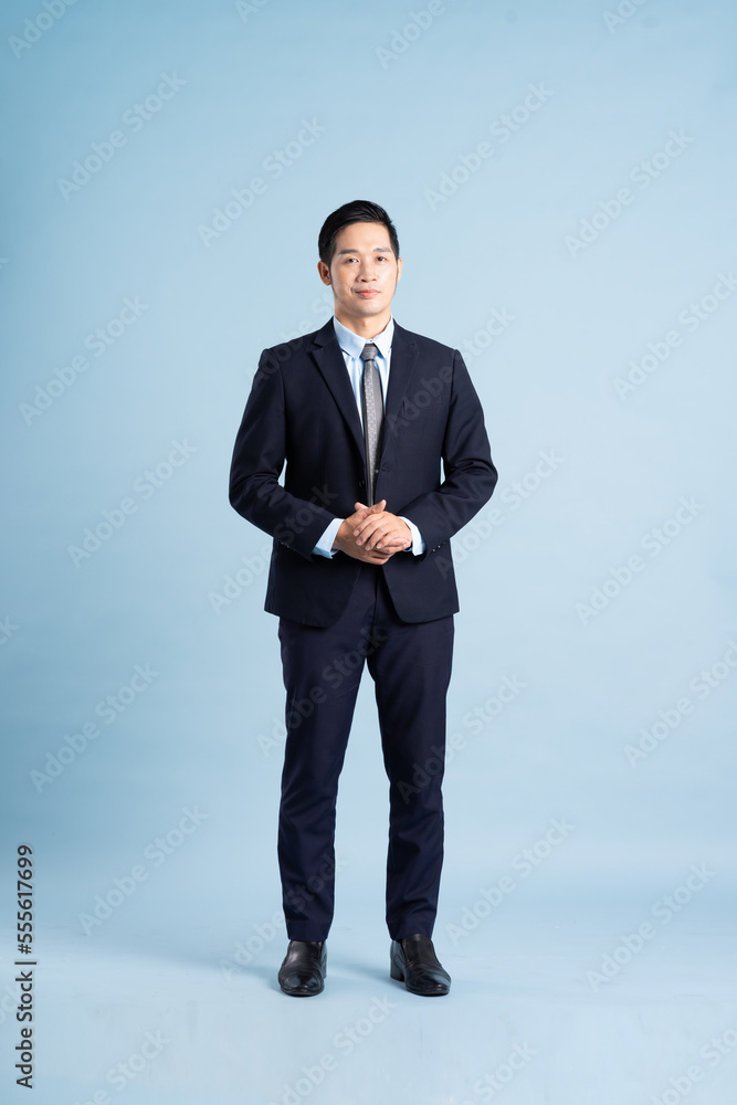 portrait of asian businessman wearing suit on blue background portrait of asian businessman wearing suit on blue background