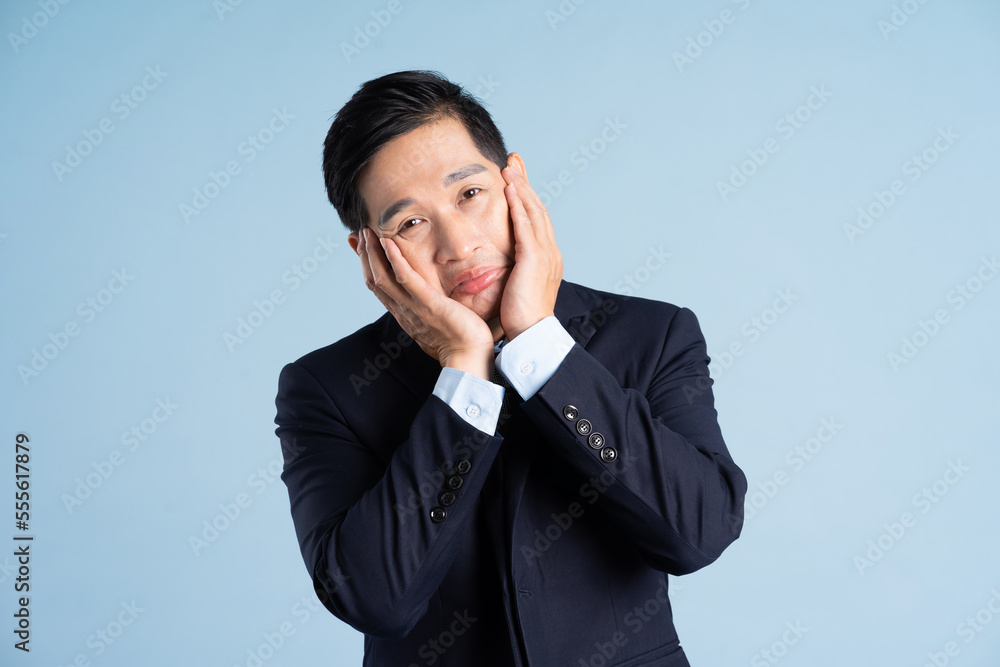 portrait of asian businessman wearing suit on blue background portrait of asian businessman wearing suit on blue background
