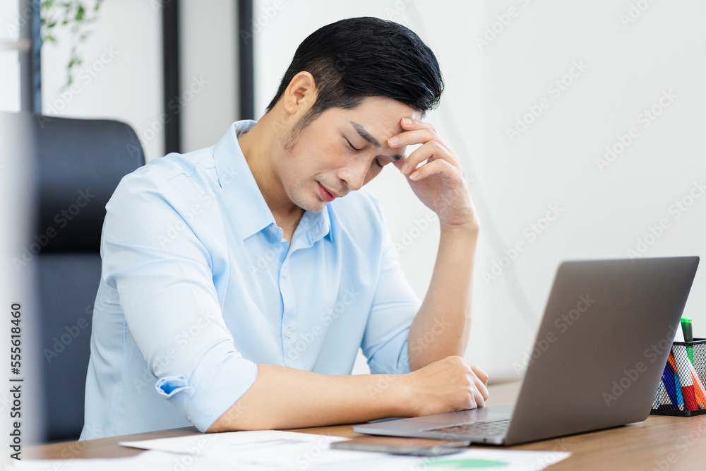 Asian businessman male portrait sitting at his desk Asian businessman male portrait sitting at his desk