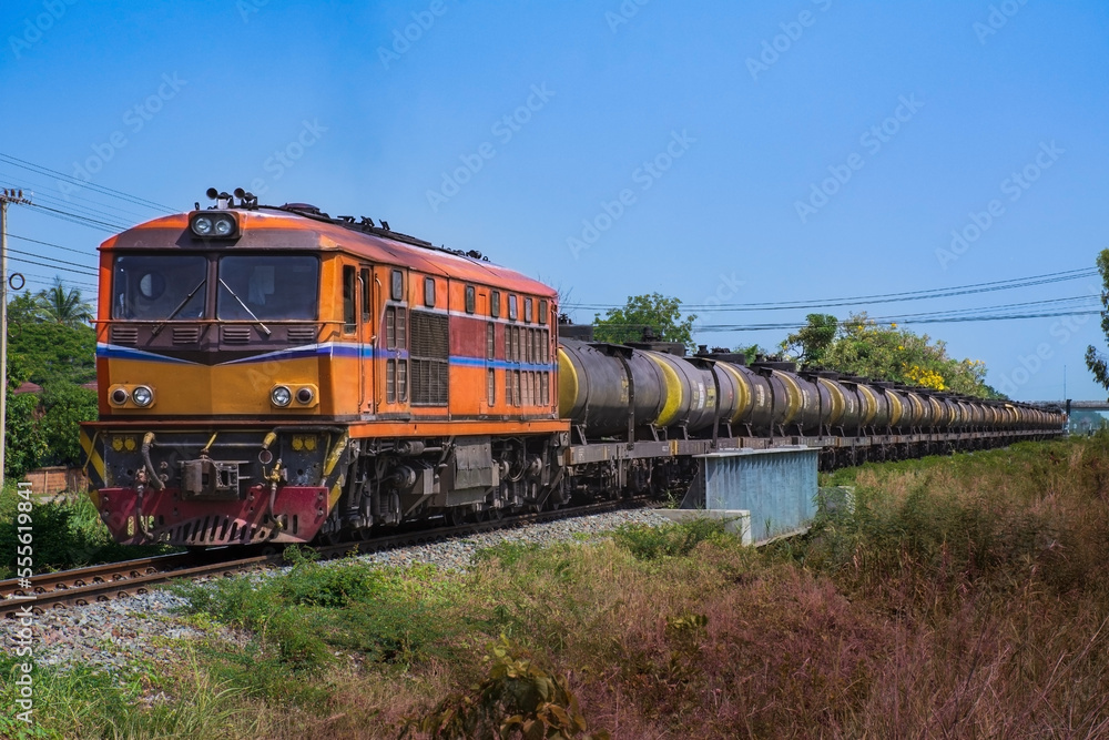 Naklejka premium Tanker-freight train by diesel locomotive on the railway.