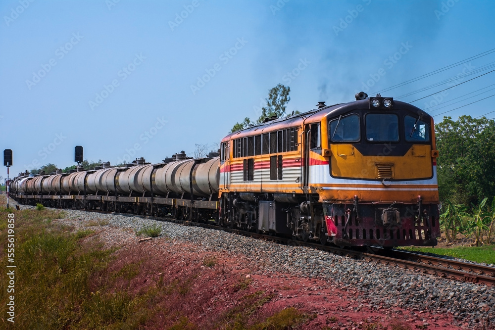Obraz premium Tanker-freight train by diesel locomotive on the railway.