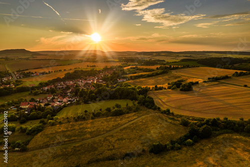 Aer ial view of a German village surrounded by meadows, farmland and forest in Germany. photo