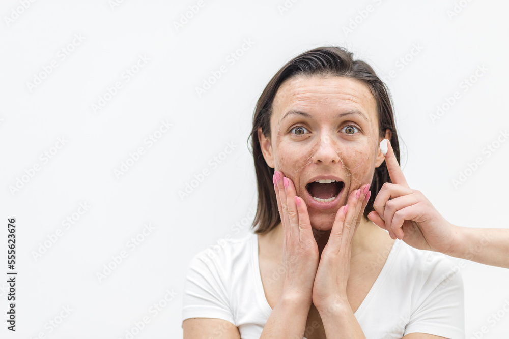 Photo of smiling woman with dry skin and a finger in a cream. Photo of smiling woman with dry skin and a finger in a cream.